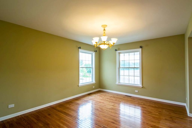 12N330 Switzer Road Elgin, IL 60124 - Photo 13 of 25 a view of empty room with wooden floor and fan
