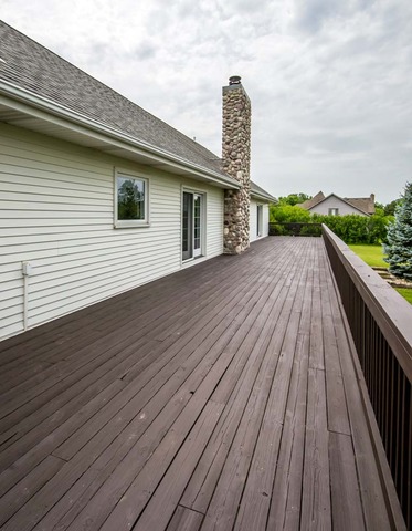 12N330 Switzer Road Elgin, IL 60124 - Photo 21 of 25 a roof deck with wooden floor and fence