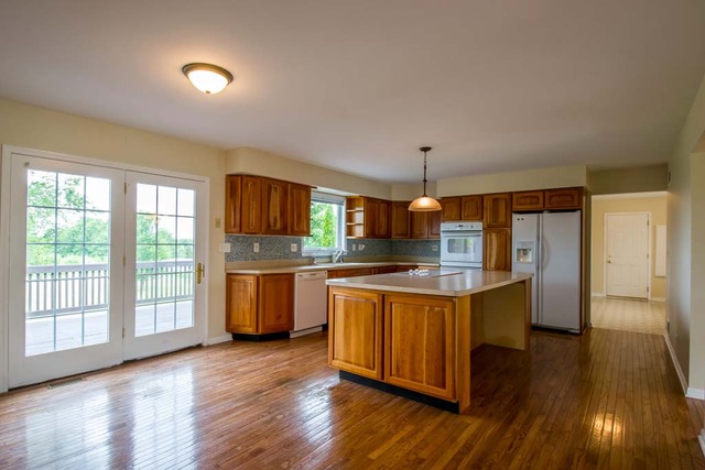 12N330 Switzer Road Elgin, IL 60124 - Photo 7 of 25 a kitchen with stainless steel appliances granite countertop a stove and a refrigerator