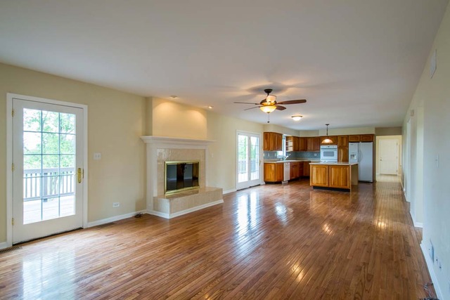 12N330 Switzer Road Elgin, IL 60124 - Photo 9 of 25 a view of an empty room with window and wooden floor