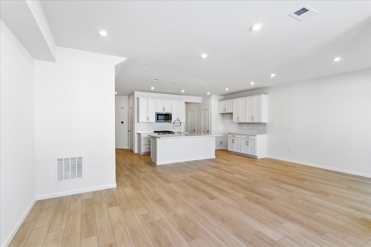 644 Switchgrass Way, Unit 59002 Bolingbrook, IL 60490 - Photo 4 of 26 a view of kitchen with wooden floor
