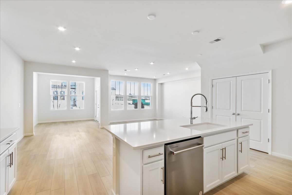 644 Switchgrass Way, Unit 59002 Bolingbrook, IL 60490 - Photo 10 of 26 a kitchen with sink and mirror
