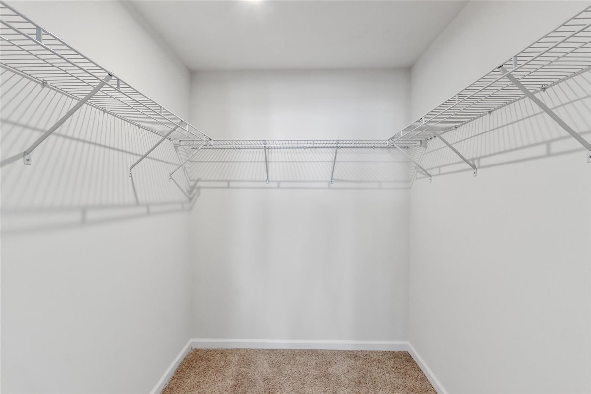 644 Switchgrass Way, Unit 59002 Bolingbrook, IL 60490 - Photo 17 of 26 a view of a room with racks on the wall