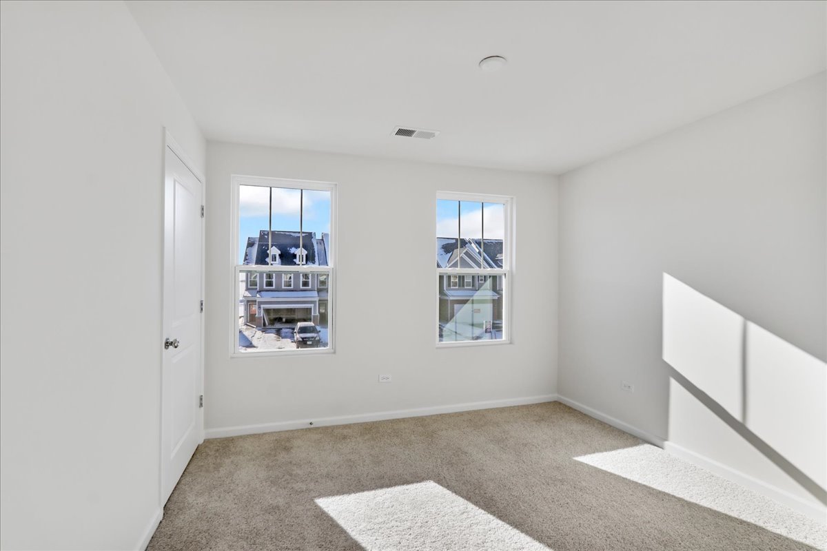 644 Switchgrass Way, Unit 59002 Bolingbrook, IL 60490 - Photo 20 of 26 a view of livingroom with window