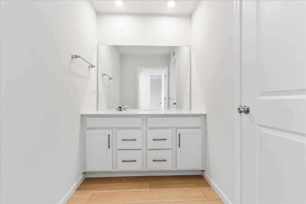 644 Switchgrass Way, Unit 59002 Bolingbrook, IL 60490 - Photo 22 of 26 a bathroom with a sink a vanity and a mirror