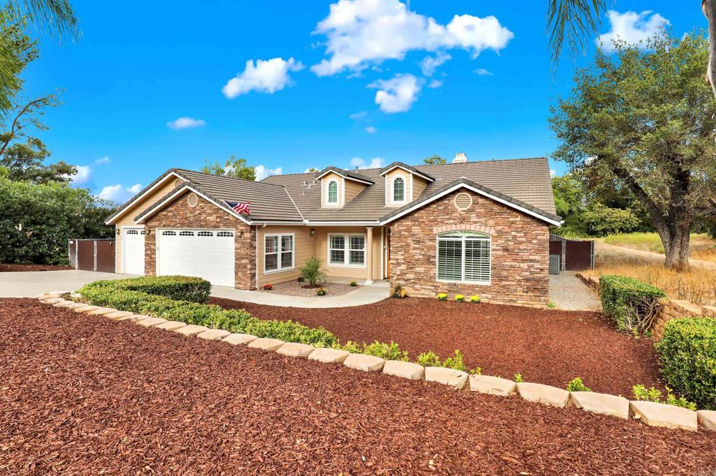 16308 Swartz Canyon Road Ramona, CA 92065 - Photo 1 of 29 a front view of a house with a yard and garage