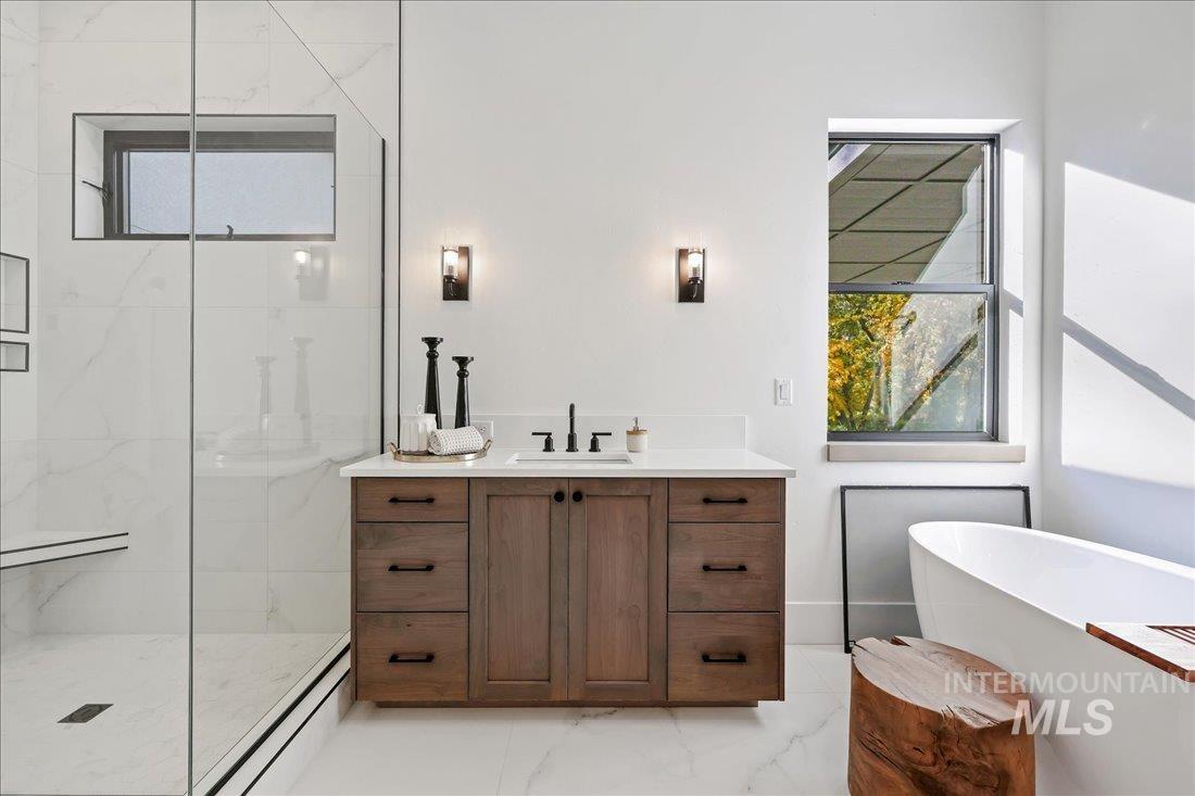 665 Watkins Street Middleton, ID 83644 - Photo 27 of 34 Bathroom featuring plenty of natural light, vanity, light marble finish floors, and a marble finish shower