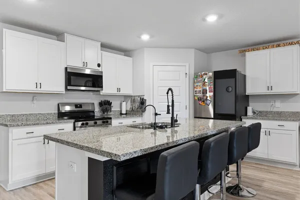 a kitchen with a refrigerator and cabinets