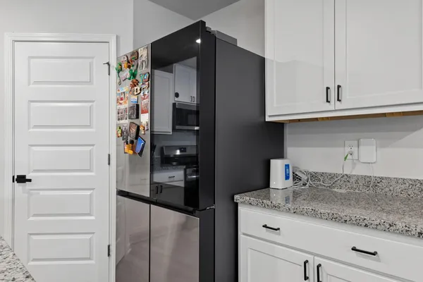 a living room with granite countertop furniture and wooden floor