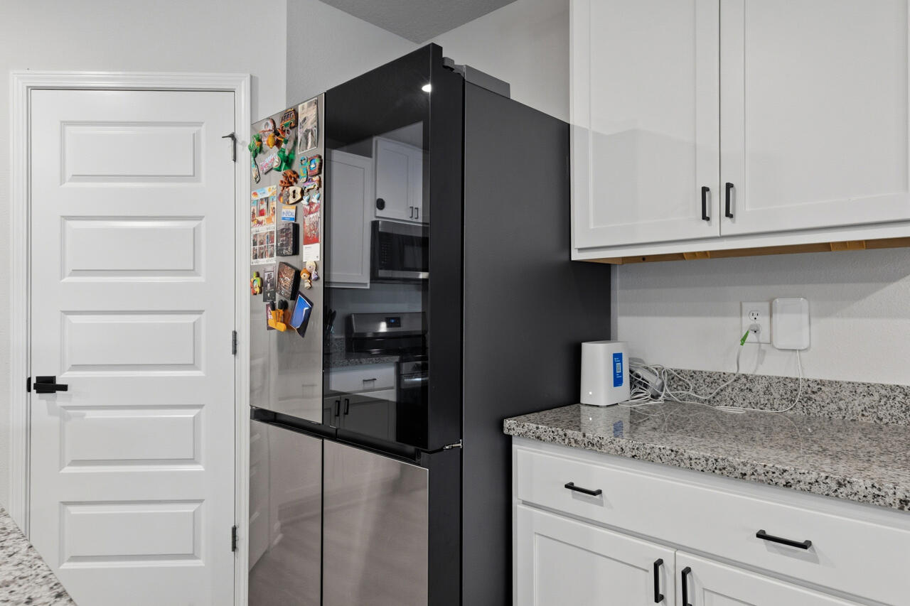 3411 Phoenix Court Crestview, FL 32539 - Photo 14 of 47 a kitchen with a refrigerator and cabinets