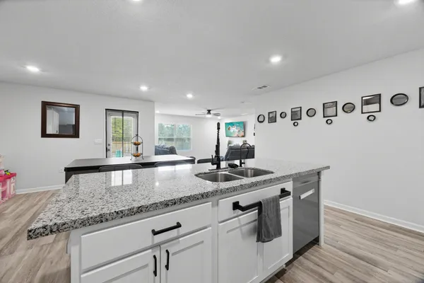 a kitchen with stainless steel appliances granite countertop a stove and a refrigerator