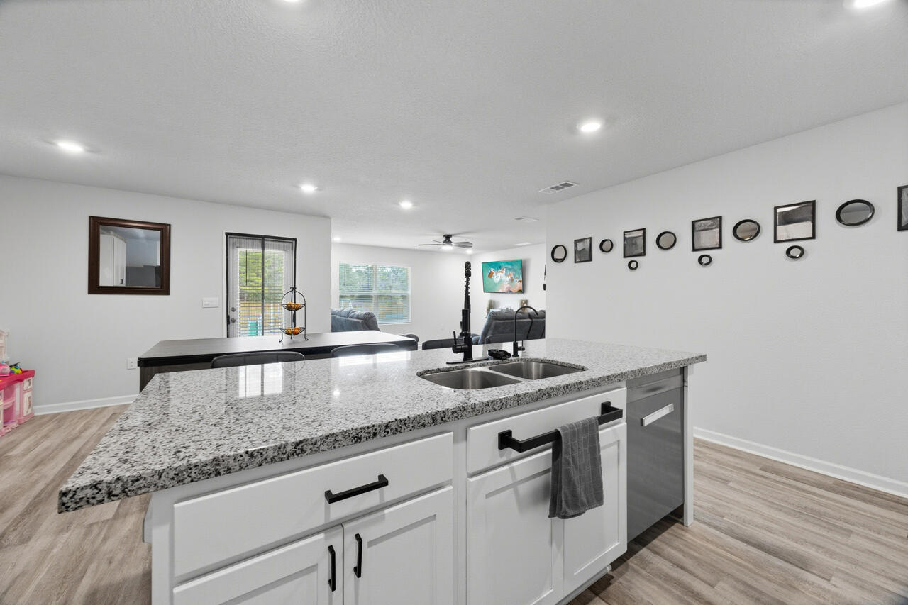 3411 Phoenix Court Crestview, FL 32539 - Photo 16 of 47 a living room with granite countertop furniture and wooden floor