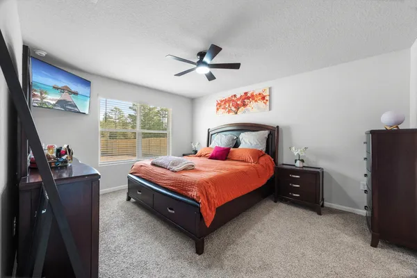 a bedroom with a bed and a dresser