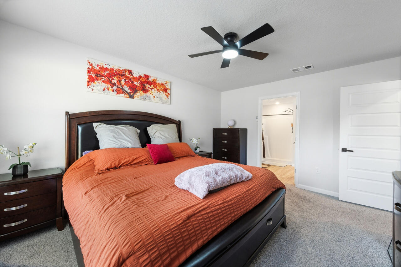 3411 Phoenix Court Crestview, FL 32539 - Photo 20 of 47 a bedroom with a bed and a chandelier