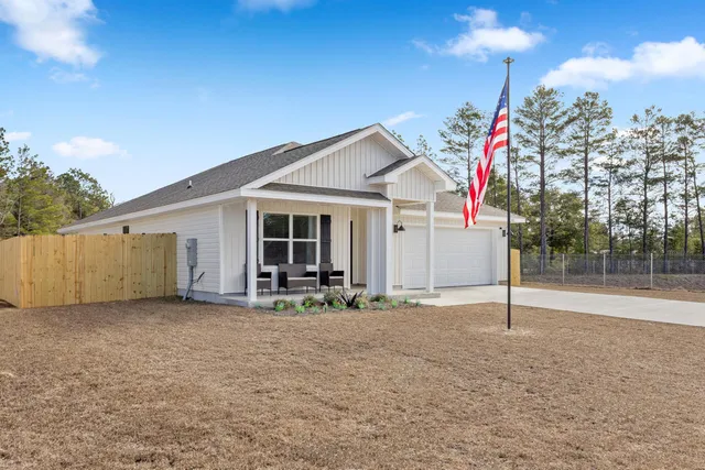 a backyard of a house with table and chairs
