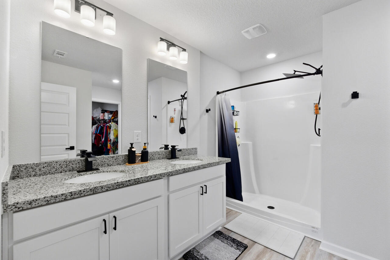 3411 Phoenix Court Crestview, FL 32539 - Photo 22 of 47 a bathroom with a granite countertop shower sink and mirror