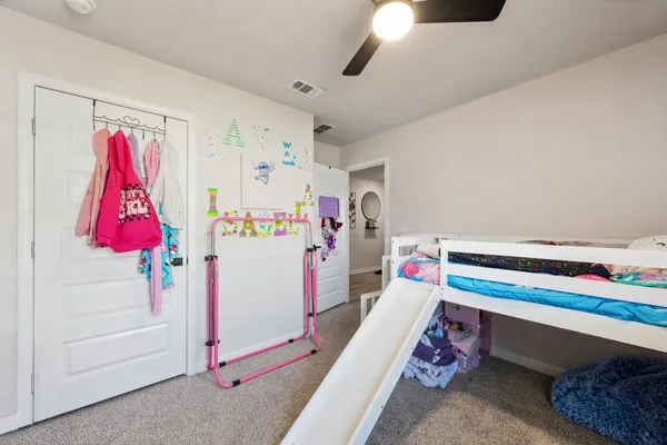 a bedroom with a bed and a chair