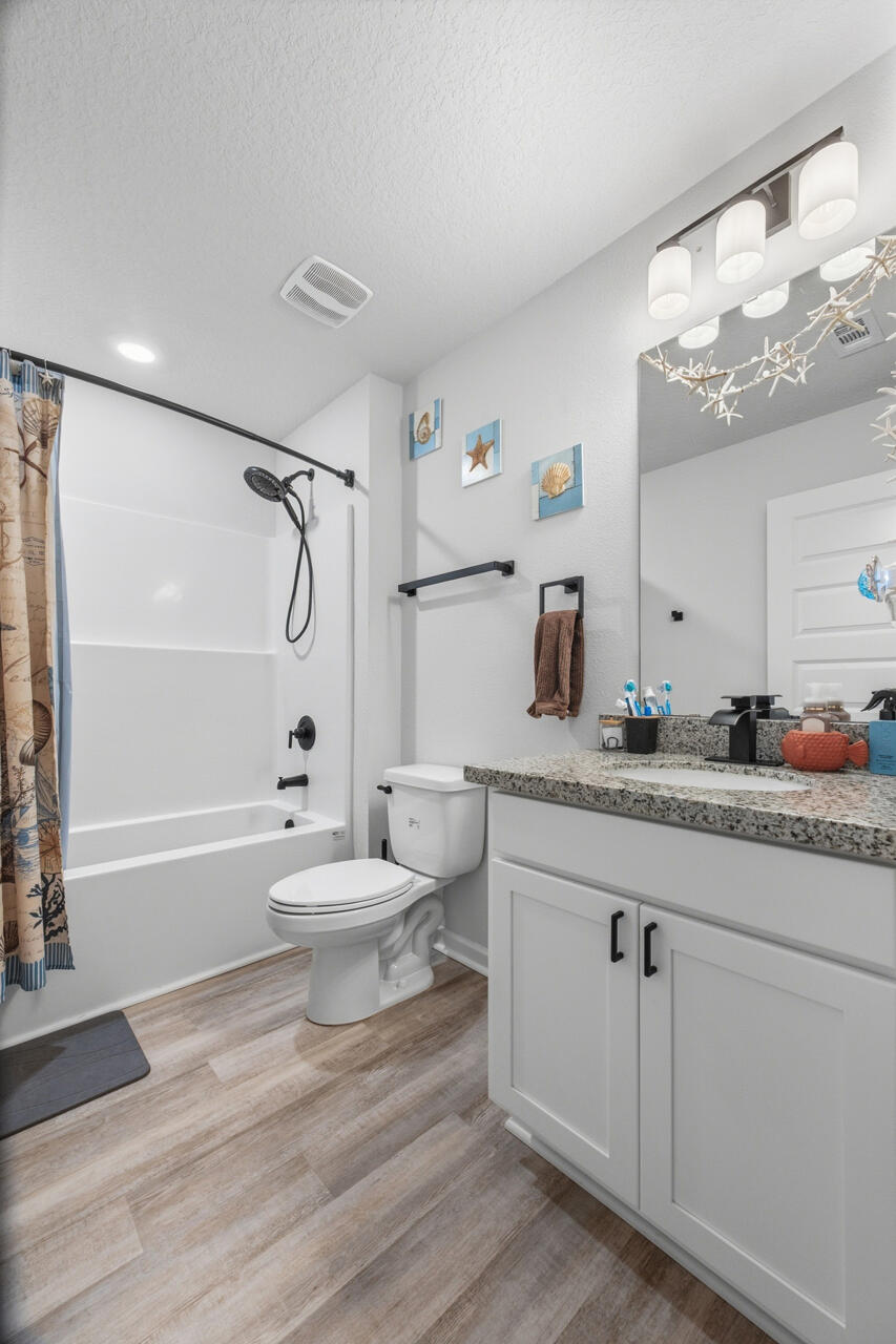 3411 Phoenix Court Crestview, FL 32539 - Photo 29 of 47 a bathroom with a granite countertop sink toilet a mirror and shower