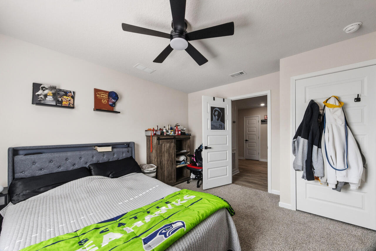 3411 Phoenix Court Crestview, FL 32539 - Photo 31 of 47 a bedroom with a bed and a chair