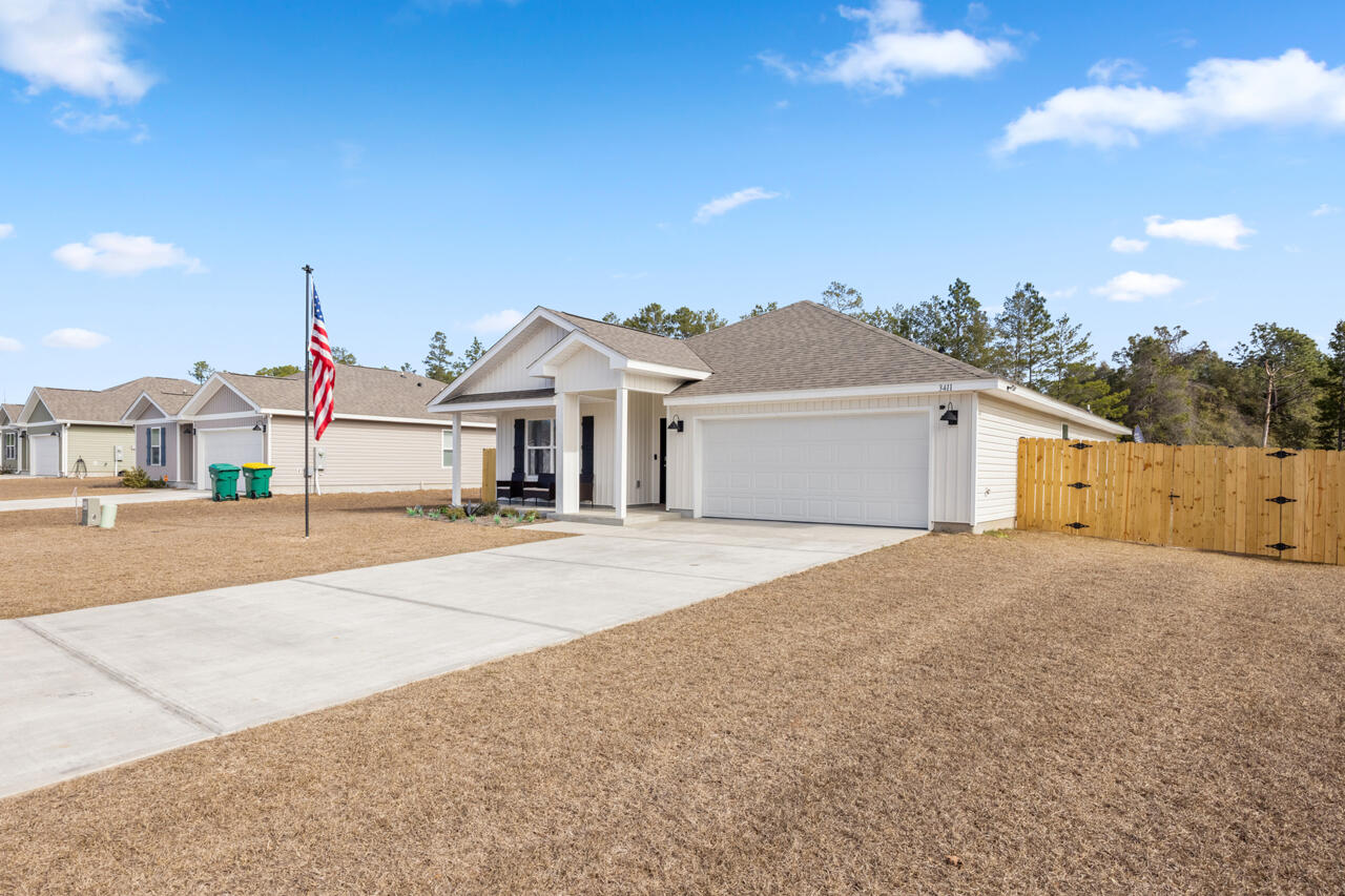 3411 Phoenix Court Crestview, FL 32539 - Photo 4 of 47 a front view of a house with a yard and garage