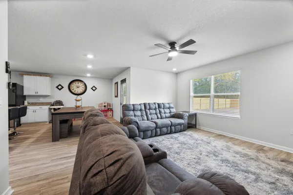 a living room with furniture and a chandelier
