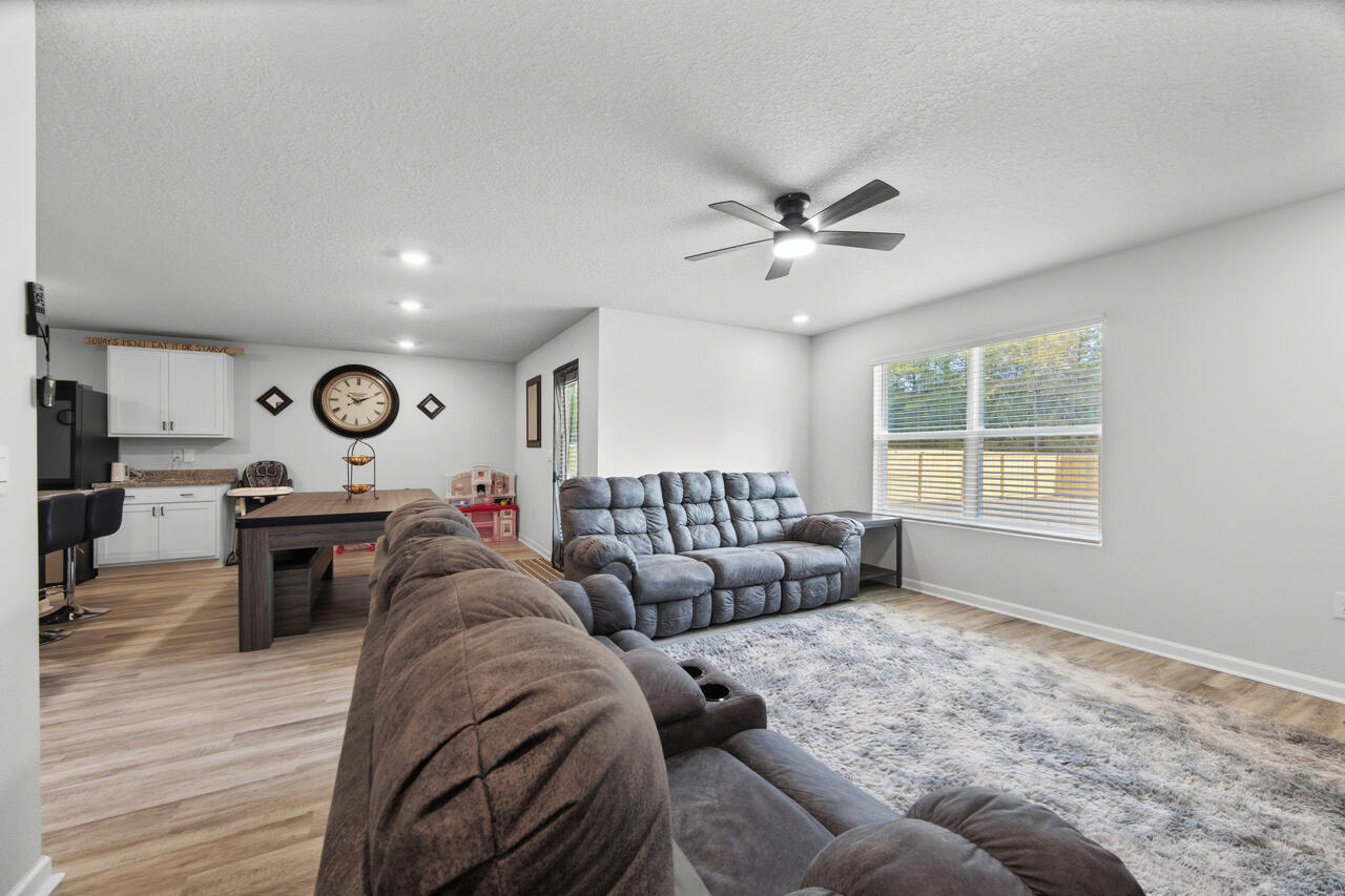 3411 Phoenix Court Crestview, FL 32539 - Photo 7 of 47 a living room with furniture and a large window