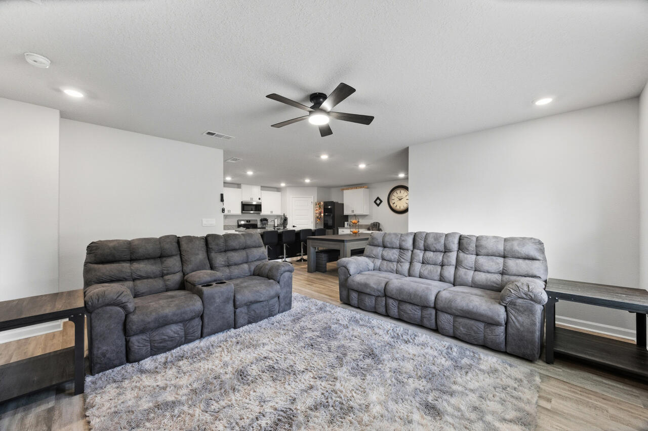 3411 Phoenix Court Crestview, FL 32539 - Photo 9 of 46 a living room with furniture and a chandelier