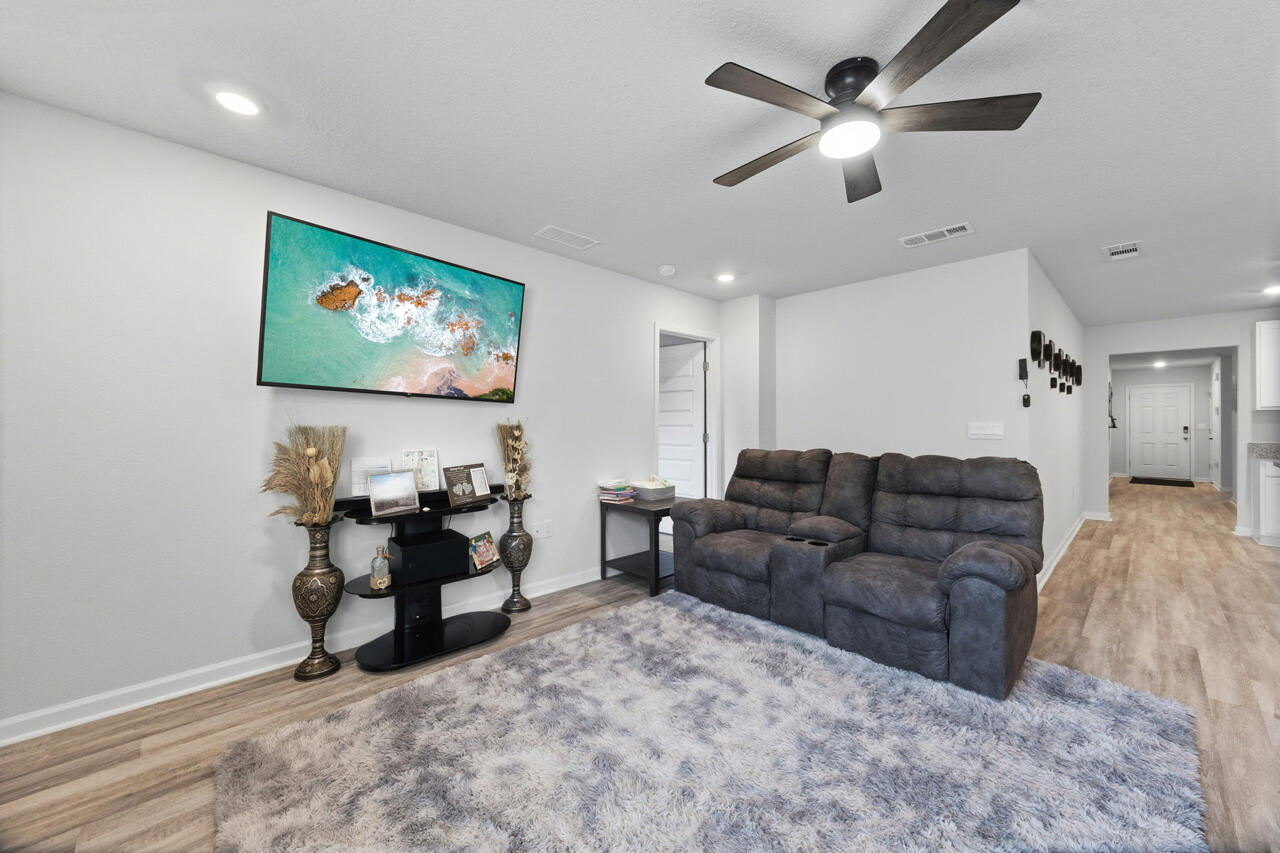 3411 Phoenix Court Crestview, FL 32539 - Photo 9 of 47 a living room with furniture and a flat screen tv