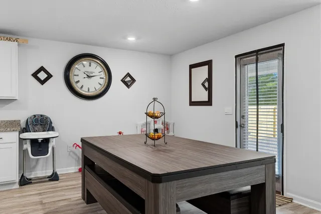a kitchen with a stove and a clock on the wall