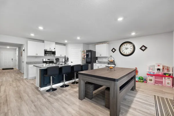 a kitchen with a stove and a clock on the wall
