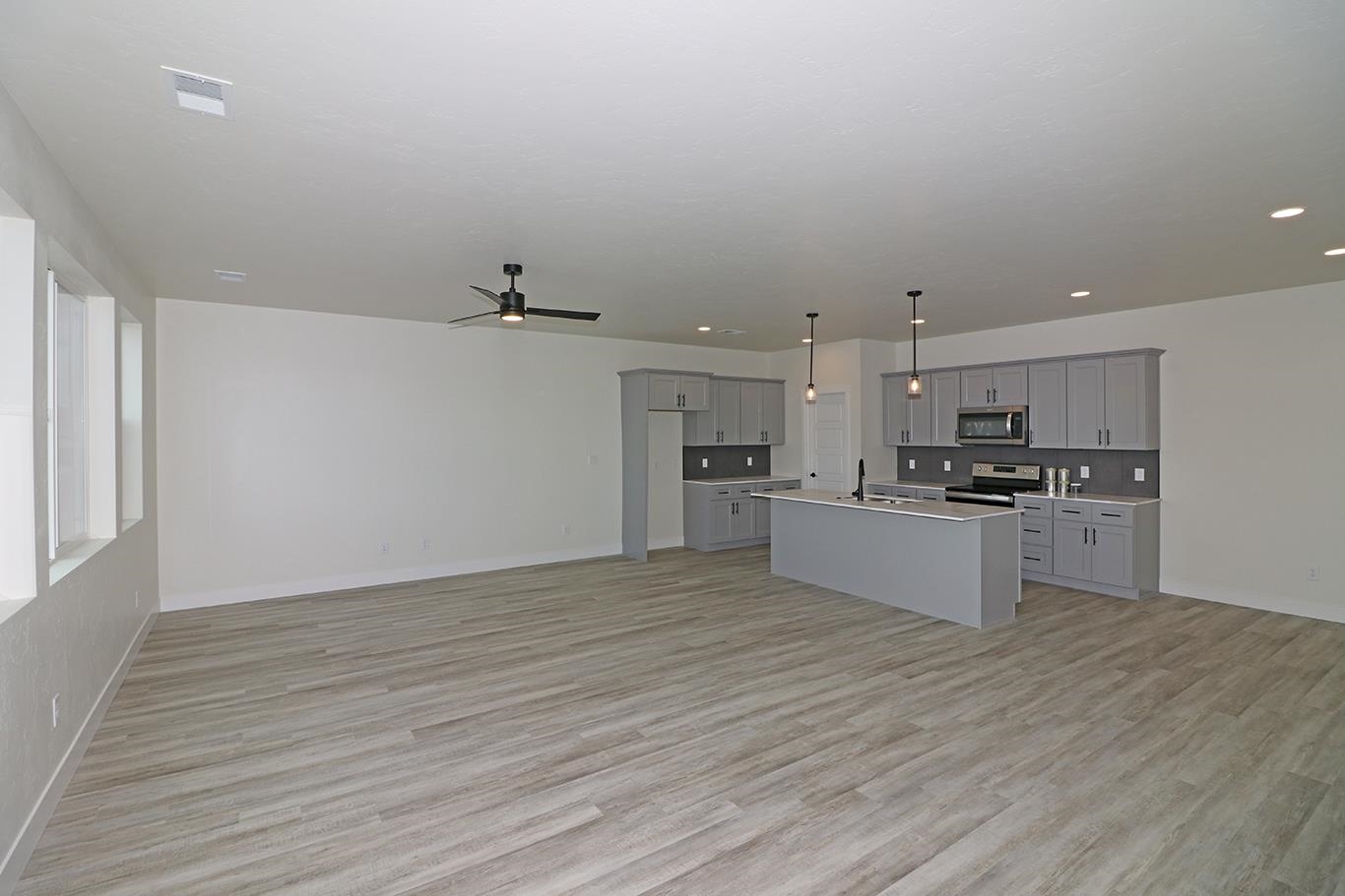 1654 Tungsten Way Fruita, CO 81521 - Photo 5 of 22 a kitchen with a refrigerator and white cabinets