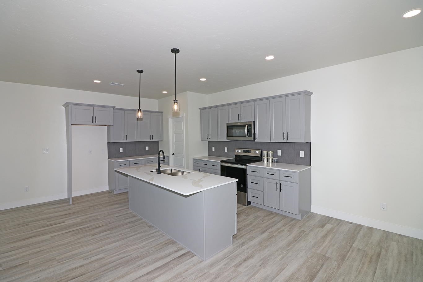 1654 Tungsten Way Fruita, CO 81521 - Photo 6 of 22 a kitchen with stainless steel appliances a sink a stove a refrigerator and cabinets