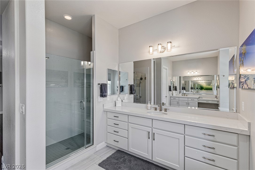 7036 Arabian Ridge Street Las Vegas, NV 89131 - Photo 32 of 64 Spa-inspired ensuite featuring a separate soaking tub, walk-in shower, and dual sinks and vanities.