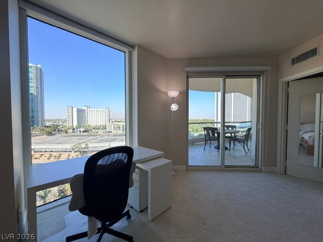 2777 Paradise Road, Unit 807 Las Vegas, NV 89109 - Photo 11 of 61 Cityscape views from an inviting interior space, with an adjacent balcony offering additional outdoor relaxation.
