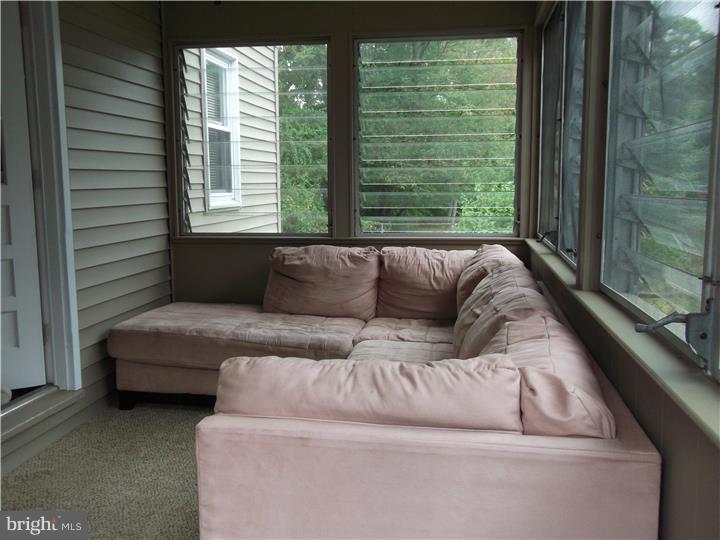 8 Collins Road Hamilton, NJ 08619 - Photo 12 of 23 a living room with furniture and a large window