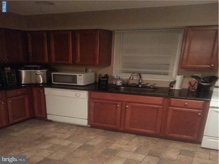 8 Collins Road Hamilton, NJ 08619 - Photo 3 of 23 a kitchen with stainless steel appliances granite countertop wooden cabinets a stove top oven a sink and dishwasher