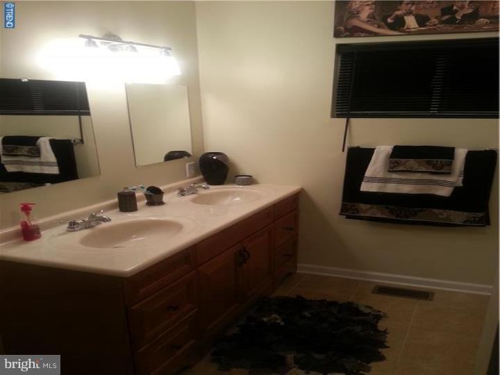 8 Collins Road Hamilton, NJ 08619 - Photo 23 of 23 a bathroom with a sink and a mirror