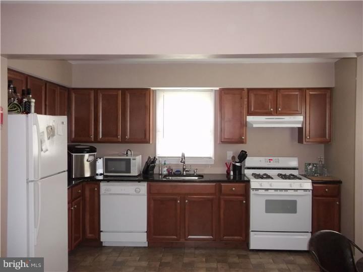 8 Collins Road Hamilton, NJ 08619 - Photo 5 of 23 a kitchen with a white stove top oven and refrigerator