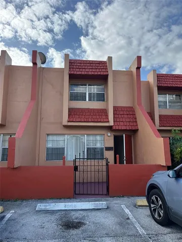 a front view of a house with parking space