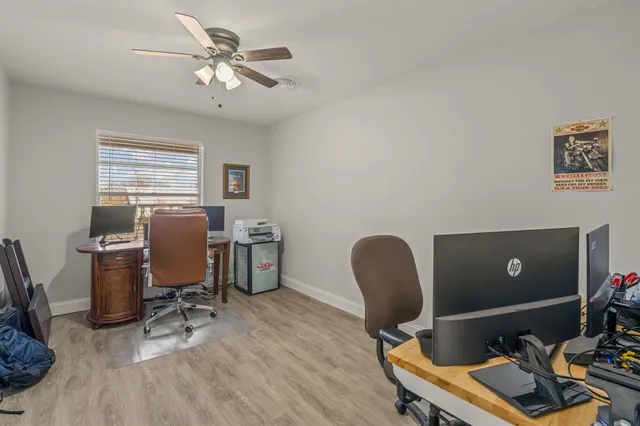 a view of a workspace with furniture and a window