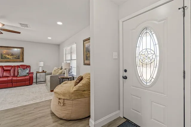 a living room with furniture a window and a mirror