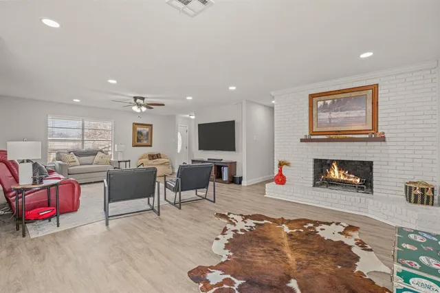 a living room with furniture flat screen tv and a fireplace