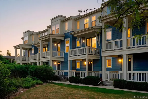 a front view of a residential apartment building with a yard