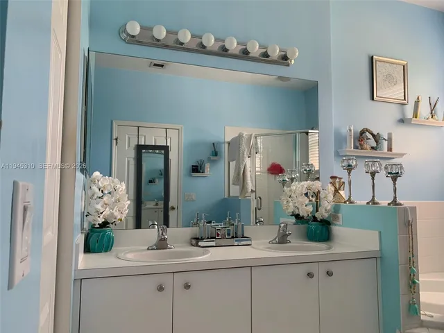 a bathroom with a sink double vanity and a mirror