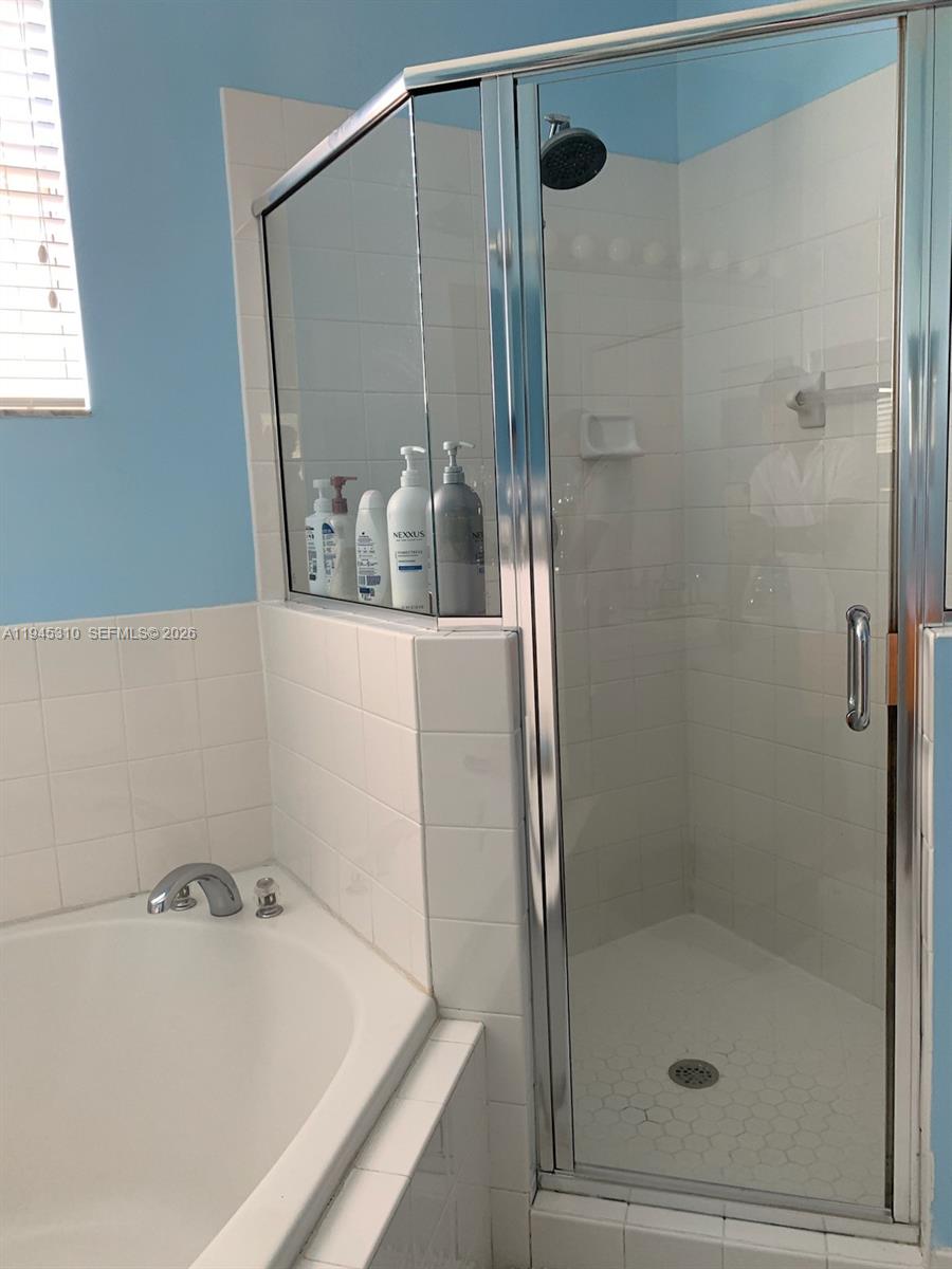 9260 Southwest 220th Street Cutler Bay, FL 33190 - Photo 15 of 20 a bathroom with a tub and shower