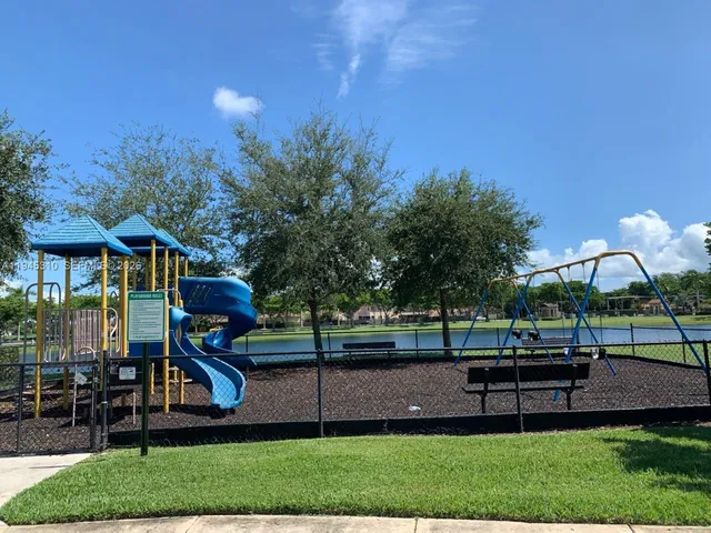 a view of a park with iron fence