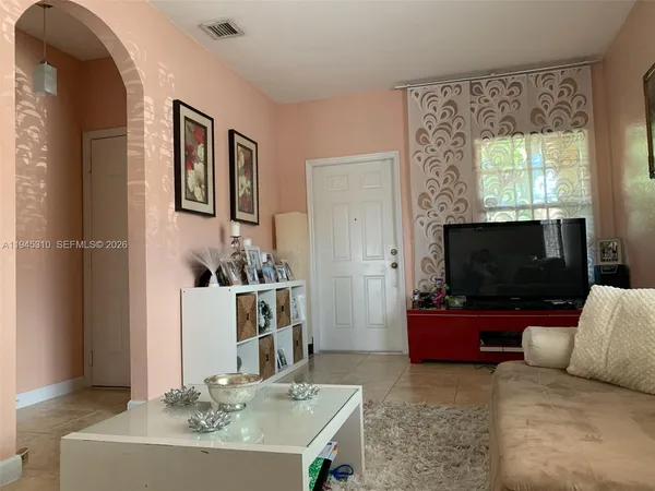 a living room with furniture and a flat screen tv