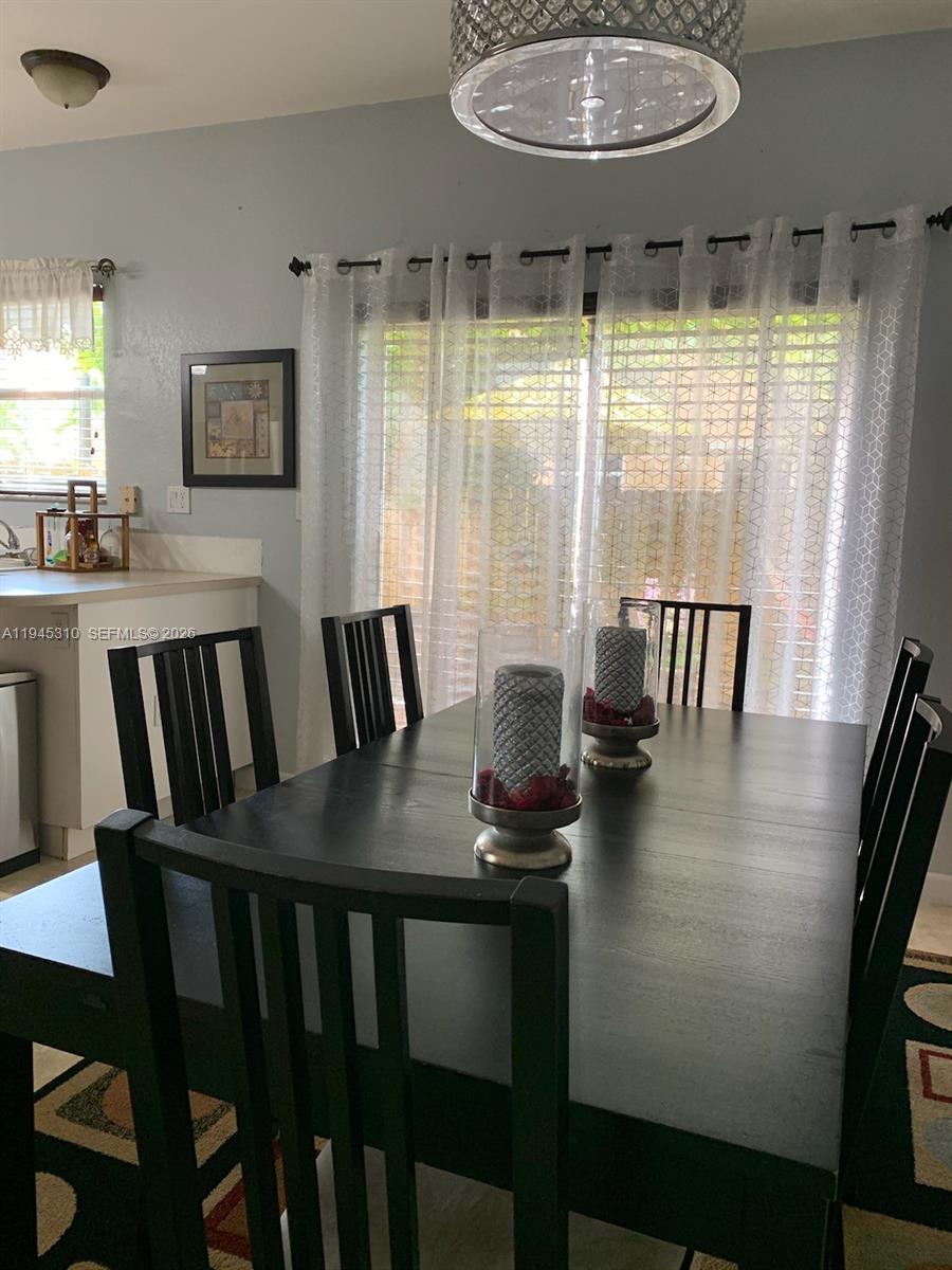 9260 Southwest 220th Street Cutler Bay, FL 33190 - Photo 6 of 20 a view of a dining room with furniture window and wooden floor