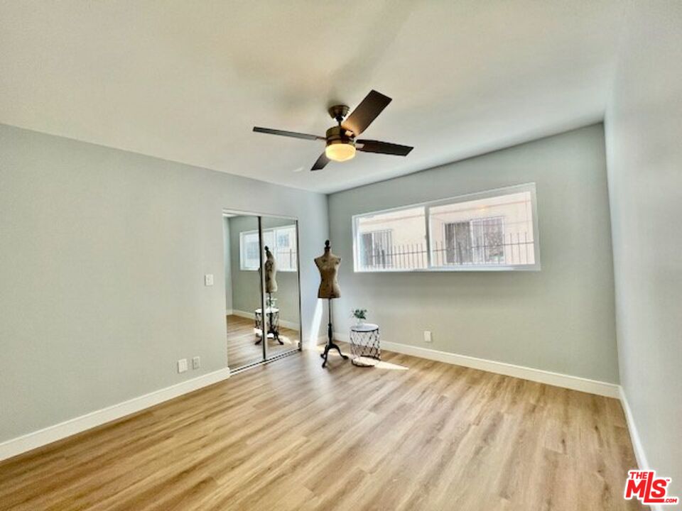 2012 South Bedford Street, Unit 1 Los Angeles, CA 90034 - Photo 10 of 17 a view of a room with wooden floor and a ceiling fan