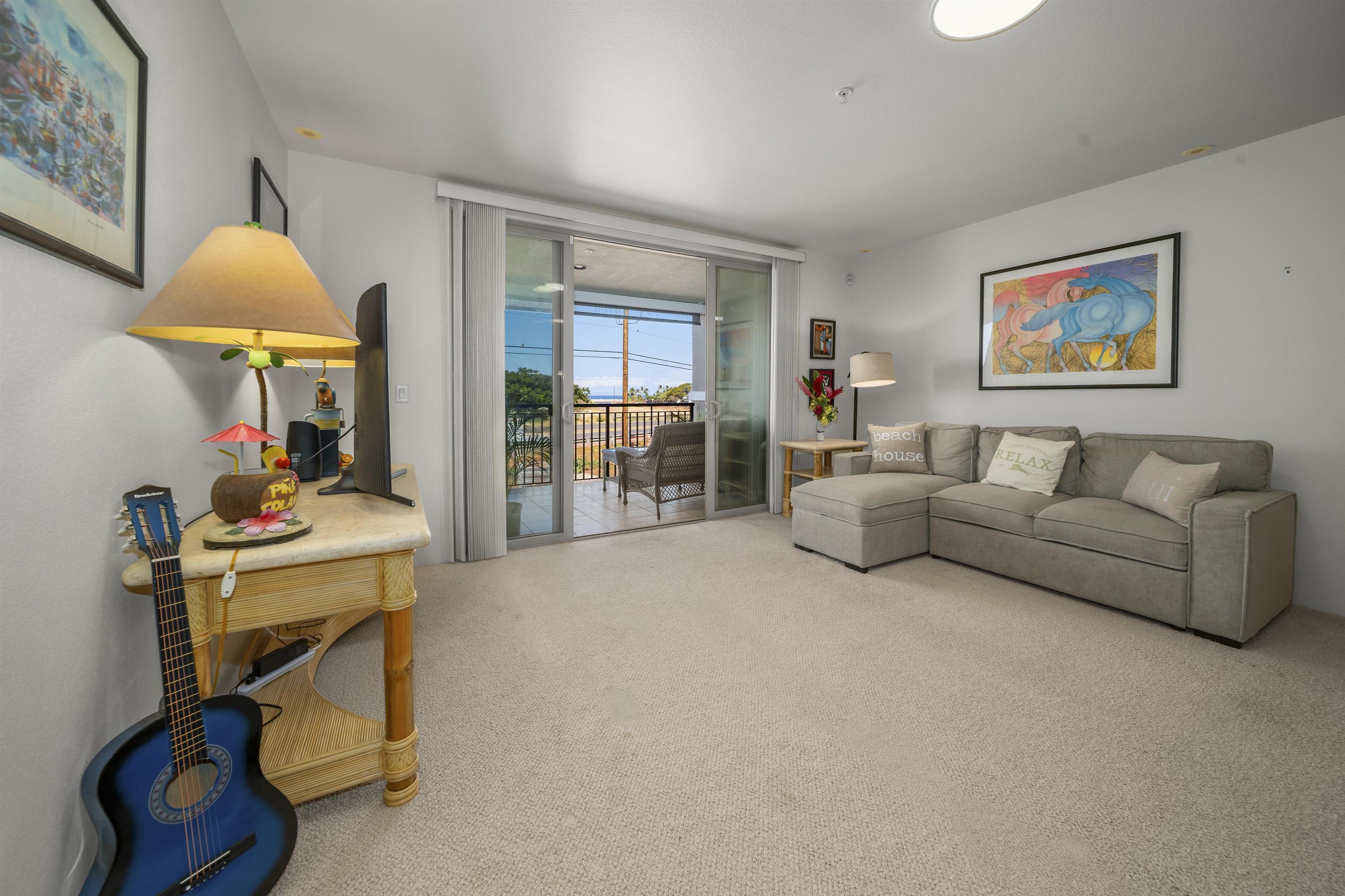 1233 Limahana Circle, Unit B202 Lahaina, HI 96761 - Photo 16 of 30 a living room with furniture and a flat screen tv